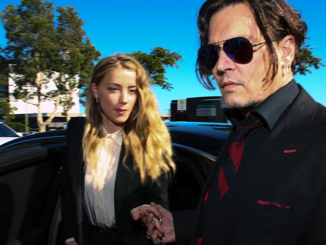 (FILES) A file photo taken on April 18, 2016, show US actor Johnny Depp (R) and his former wife Amber Heard arriving at a court in the Gold Coast. Johnny Depp's Australian nemesis, Deputy Prime Minister Barnaby Joyce, suggested on June 27, 2017 he could unleash perjury charges against the Hollywood A-lister in the latest chapter to a case dubbed the "war on terrier". Depp and his then-wife Amber Heard fell foul of Australia's strict quarantine laws when they failed to declare her pet dogs Pistol and Boo on arrival in the country on a private jet in 2015.  / AFP PHOTO / PATRICK HAMILTON