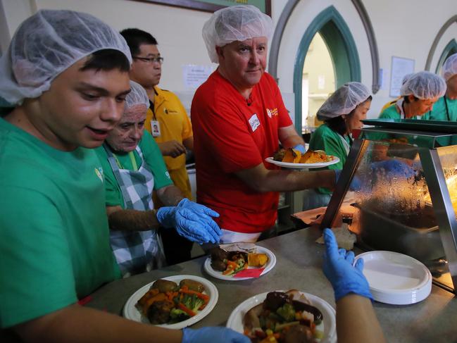 Federal Opposition Leader Anthony Albanese serves food to disadvantaged and homeless people on Christmas Day at the Exodus Foundation in Sydney, Wednesday, December 25, 2019. (AAP Image/Steven Saphore) NO ARCHIVING