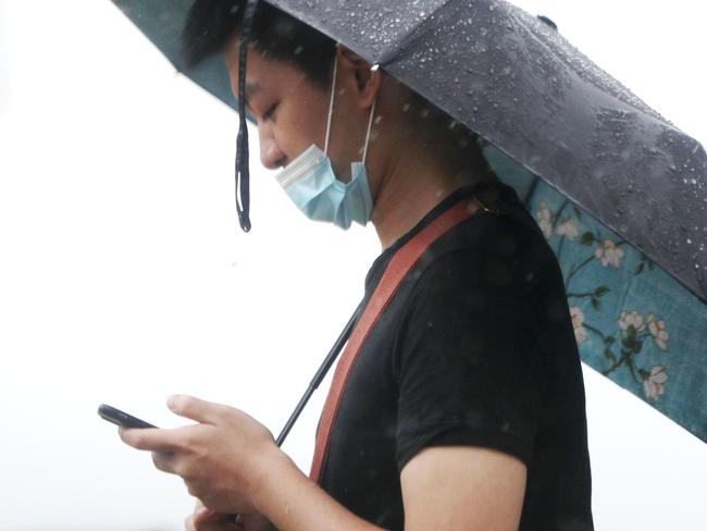 Flooding & Rain on the Gold Coast.People wear face masks in Surfers Paradise on the Gold Coast.* coronavirus *Picture: NIGEL HALLETT