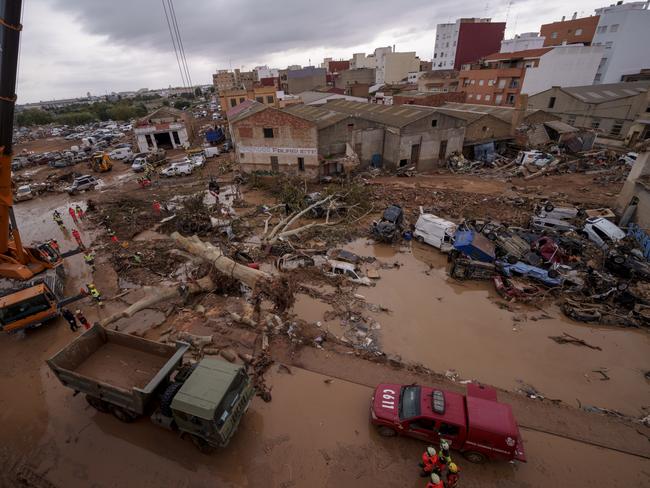 Emergency services remove cars in an area affected by floods in Catarroja, Spain. Picture: AP