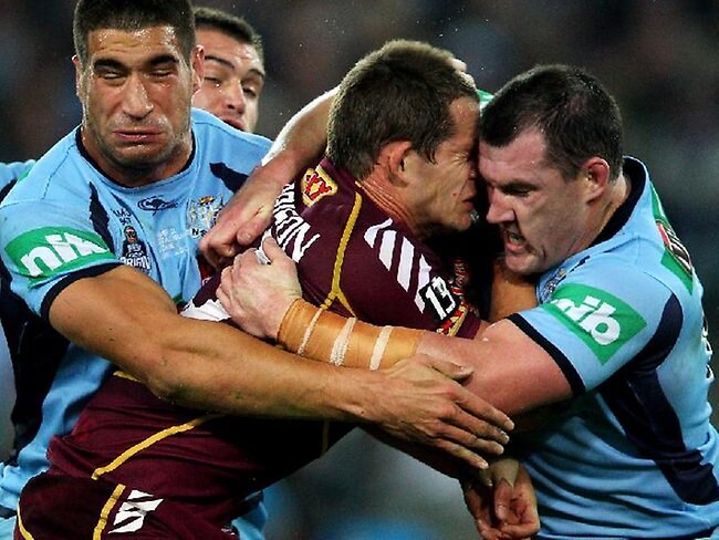 State of Origin II, 2012: Queensland's Ashley Harrison charges into the tackle of James Tamou (left) and Paul Gallen.