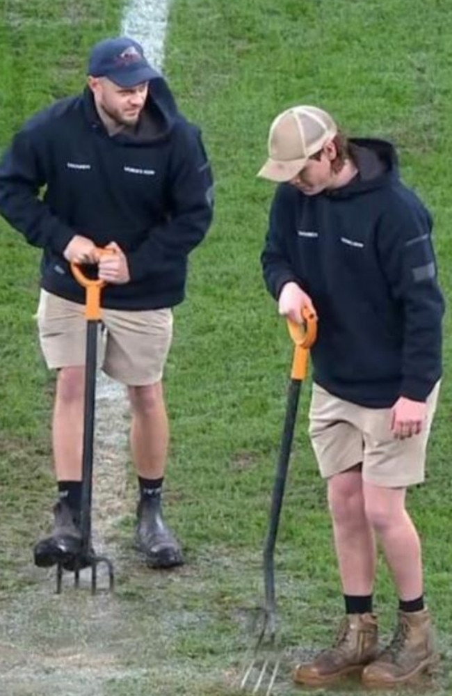 Allianz ground staff out in the middle of Allianz Stadium with pitchforks trying to drain the water during last night match between the Roosters and Eels. Fox Sports.