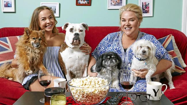 Angie Kent and Yvie Jones and their poochies on the couch for Gogglebox.