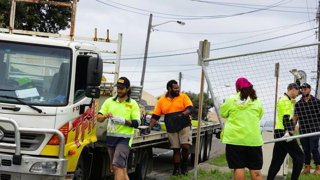 Workers erect temporary fencing around Dudley Page Reserve. Picture: NCA NewsWire / Gaye Gerard