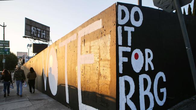 People in Los Angeles walk past a mural honoring Supreme Court Justice Ruth Bader Ginsburg. Picture: Mario Tama/Getty Images