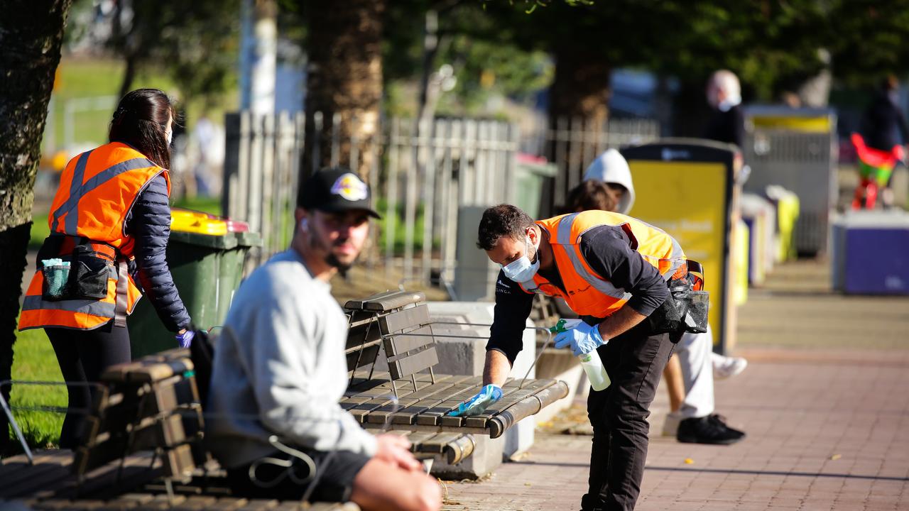 Cleaners sanitising public benches and bus stops along the main road in Bondi Beach. Picture: NCA NewsWire / Gaye Gerard