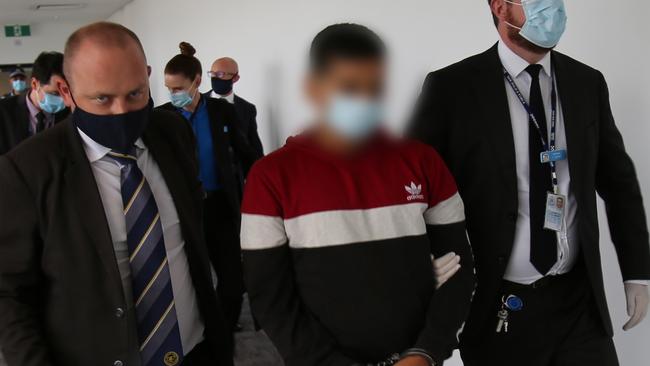 Detectives arrive back in Sydney after extraditing Valencia (centre). Picture: NSW Police