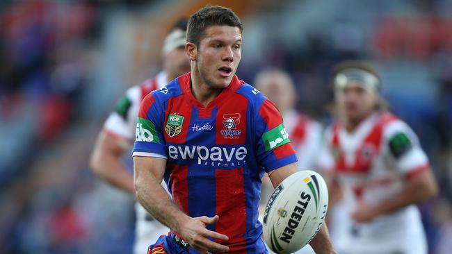 NEWCASTLE, AUSTRALIA — JUNE 25: Jack Cogger of the Knights passes the ball during the round 16 NRL match between the Newcastle Knights and the St George Illawarra Dragons at Hunter Stadium on June 25, 2016 in Newcastle, Australia. (Photo by Tony Feder/Getty Images)