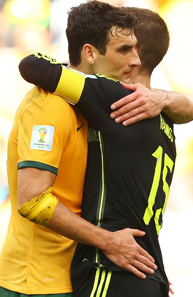 Mile Jedinak embraces Sergio Ramos after the game in Curitiba.