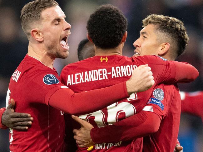 Liverpool's team celebrates scoring during the UEFA Champions League Group E football match between RB Salzburg and Liverpool FC on December 10, 2019 in Salzburg, Austria. (Photo by JOE KLAMAR / AFP)