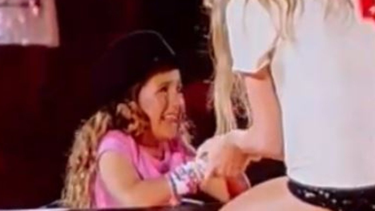 Taylor swift gives her hat to a young fan during her performance of 22 at the MCG on Friday night. Source: Twitter