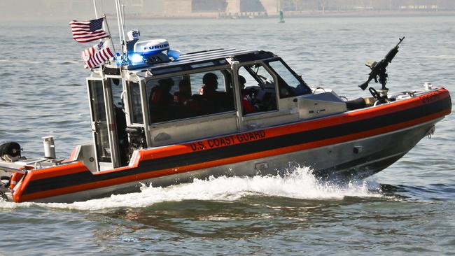 A U.S. Coast Guard gun-mounted boat patrol the Hudson River in view of the Statue of Liberty on Wednesday, March 9, 2016, in New York. (AP Photo/Bebeto Matthews)