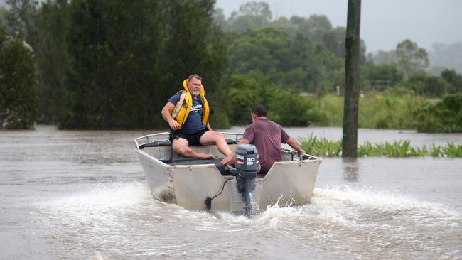 Duane Deegenaaes and his brother Scott race to rescue a man they found clinging to a tree in raging floodwaters at Telegraph Point north of Port Macquarie, on Friday. Picture: Nathan Edwards