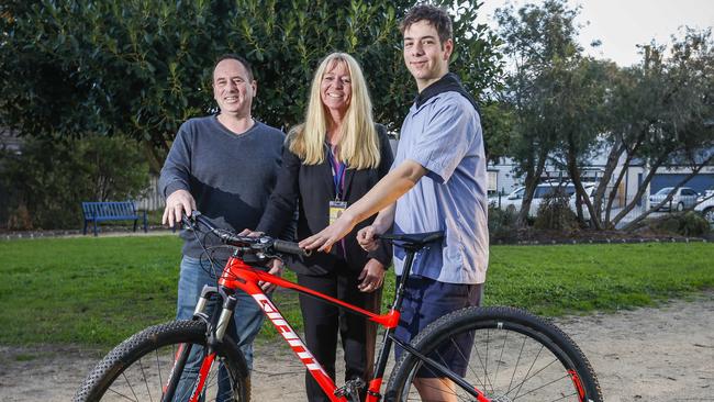 Jon Taylor and his bike with dad Scott Taylor and Moorabbin detective Senior Constable Susanna Hughes. Picture: Valeriu Campan