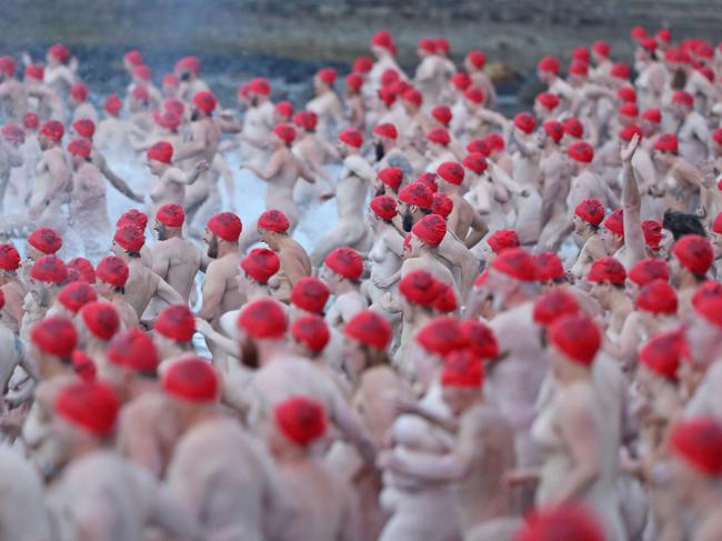 DARK MOFO 2019: Participants of the nude solstice swim brave the cold water at dawn at Long Beach, Sandy Bay. Picture: LUKE BOWDEN