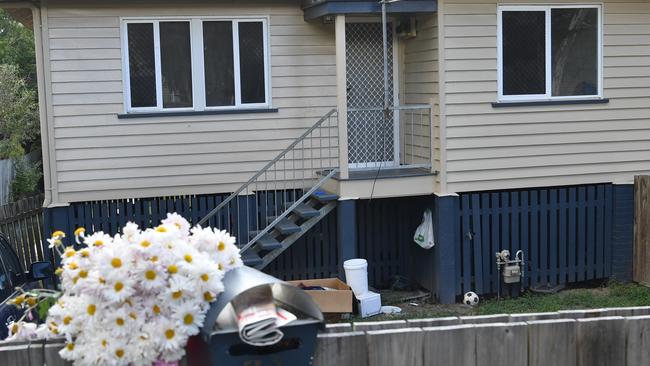 Flowers outside a Brisbane house where two teenage boys were found living in squalid conditions. Picture: AAP Image/Darren England