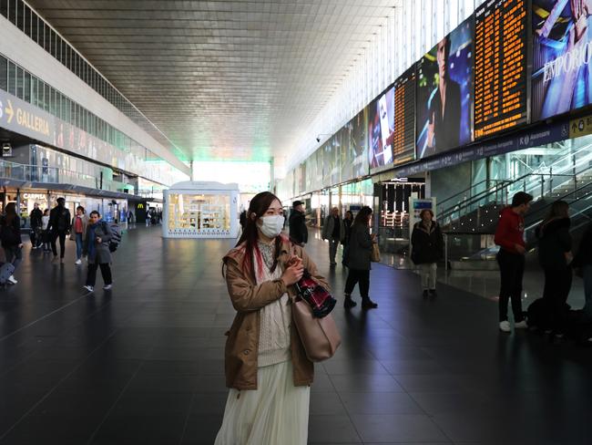 A passenger wears a protective mask while waiting at Termini Central Station in Rome. Picture: Marco Di Lauro/Getty