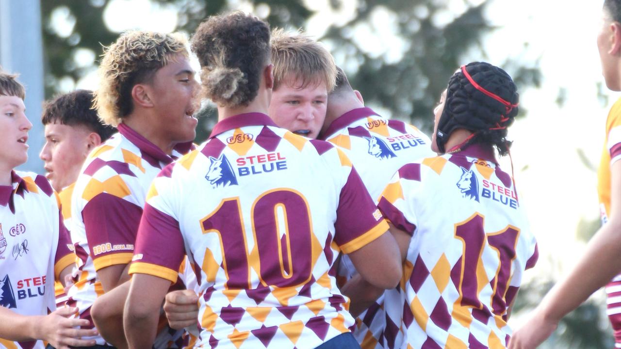 Jack Neuendorf is swarmed by teammates after scoring the first try.