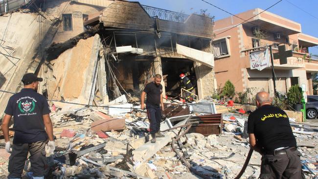 Rescuers inspect the debris at the site of an overnight Israeli strike on a pharmacy in the southern Lebanese village of Akbiyeh. Picture: AFP