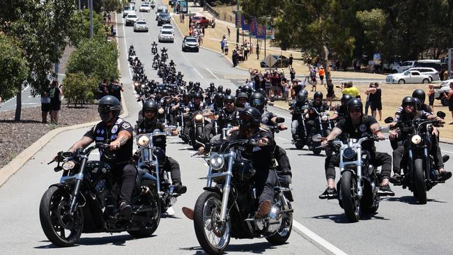 Dozens of bikies follow the casket.