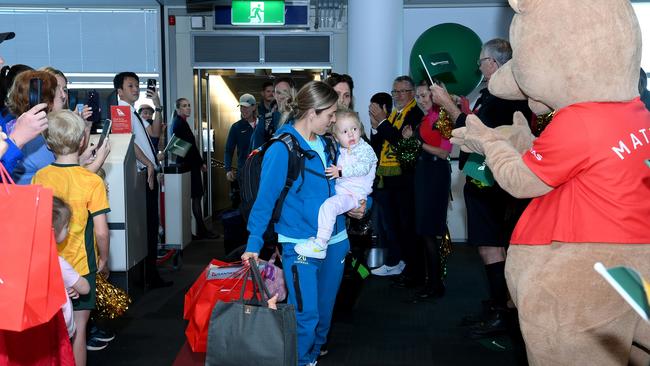 Katrina Gorry of the Australia Matildas is seen with her daughter Harper as they arrive in Brisbane following the team's loss to England in last night's FIFA Women's World Cup.