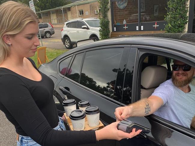 The first customer through Fahrenheit Cafe's makeshift drive through bay at East Gosford before it was temporarily shut down. Picture: supplied