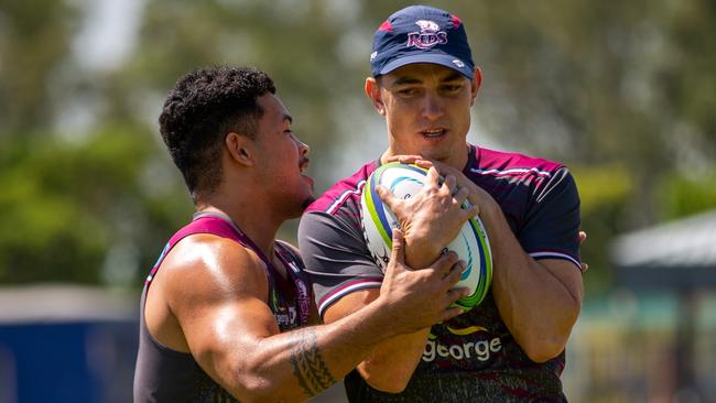 Queensland Reds winger Jock Campbell is tackled by Hunter Paisami during training in Johannesburg. Picture: QRU / Tom Mitchell