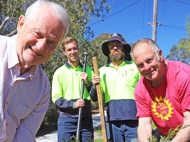 Hornsby Shire Mayor Philip Ruddock and Councillor Mick Marr, planting the 12,500th tree with the assistance of Council staff members Brendan Martin and Duane Artis.