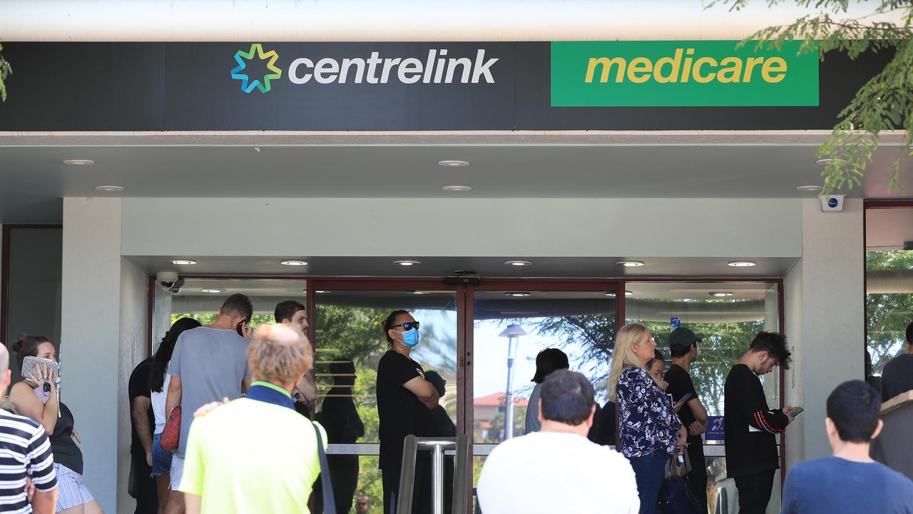 Lines of people wait at Southport Centrelink. Picture: Adam Head.