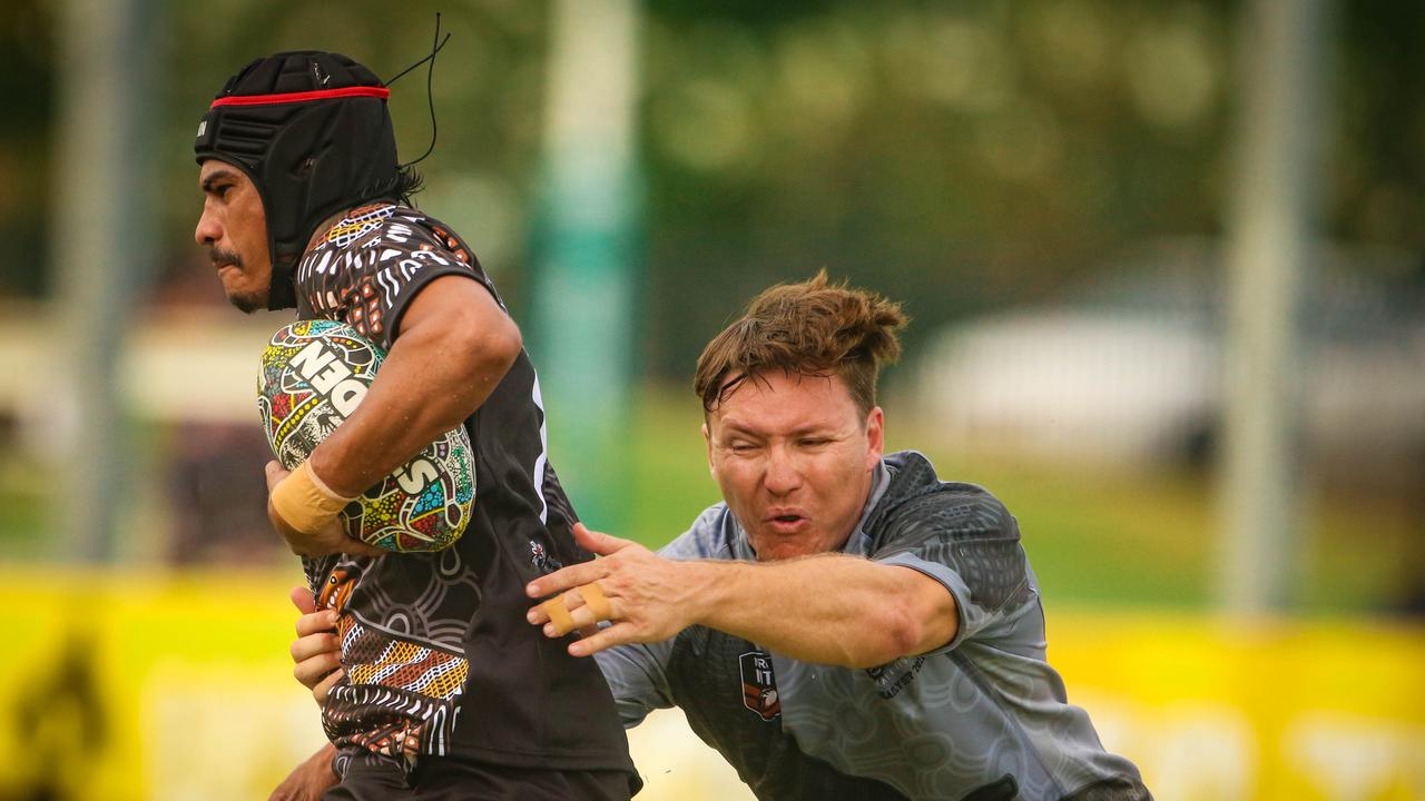 Shem Williams -Brown evades Robert Butcher as the Indigenous All Stars take on the Territory All Stars in the senior men’s rugby league Deadly Cup matchup. Picture: Glenn Campbell