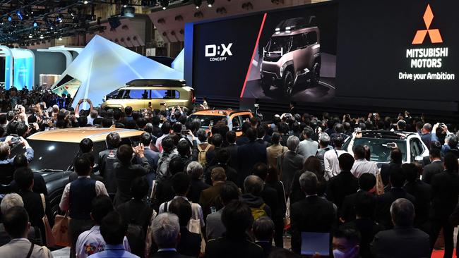 People attend a Mitsubishi Motors briefing during the press day of the Japan Mobility Show in Tokyo on October 25, 2023. Photo: Kazuhiro NOGI / AFP