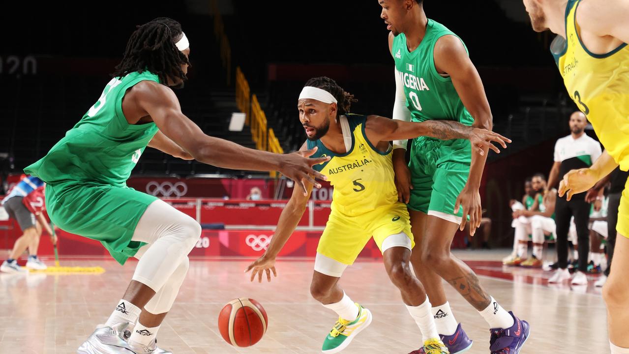 Patty Mills #5 of Team Australia looks to pass as he's surrounded by Team Nigeria defenders in the first half of the Men's Preliminary Round Group B game on day two of the Tokyo 2020 Olympic Games. Picture: Gregory Shamus – Getty Images