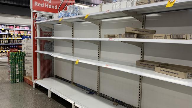 Empty shelves at The Glen Coles due to panic buying of bottled water after some Melbourne water sources have been contaminated after Thursday's storm. Picture: Suzan Delibasic