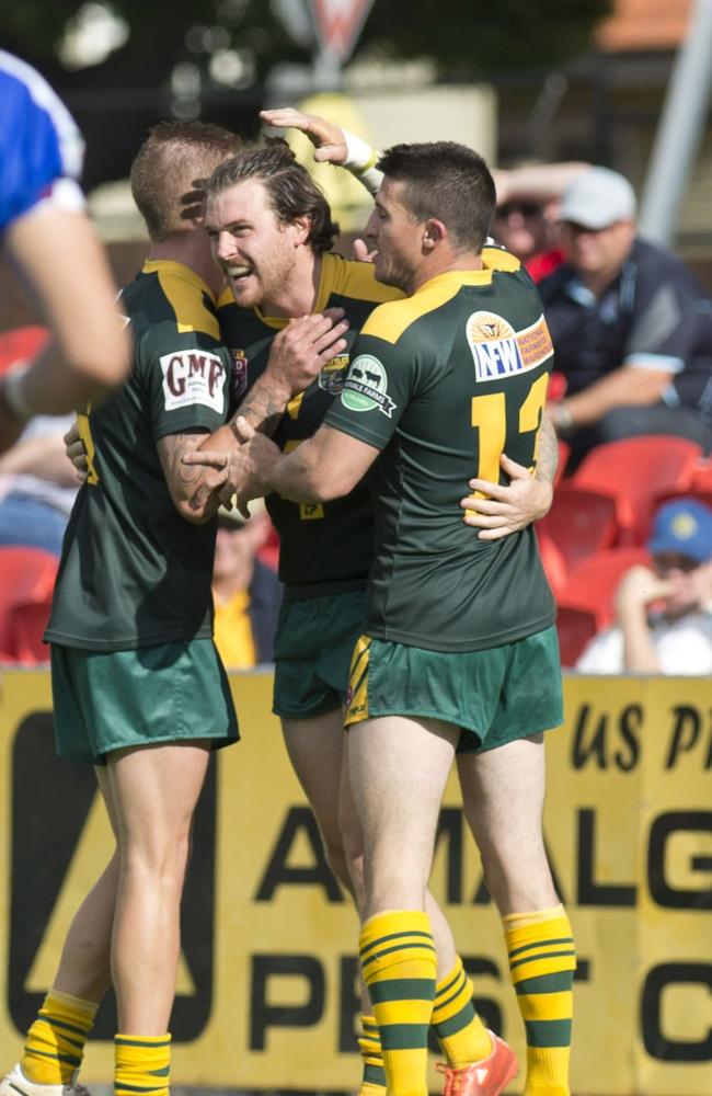 Brodie Ciesiolka, Joel Koina and Ryan Duggan celebrate Joel's try for Wattles. TRL Grand Final, Wattles vs Dalby Diehards. Sunday, Sep 27, 2015. Photo Nev Madsen / The Chronicle