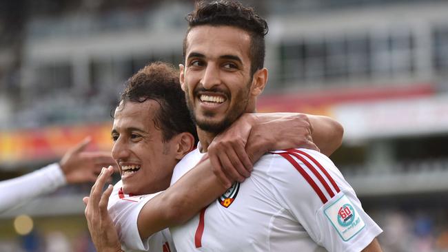 Mohamed (L) and scorer Ali Ahmed Mabkhout (R) of UAE react after a goal during the Asian Cup football match between UAE and Qatar in Canberra on January 11, 2015. AFP PHOTO / MARK GRAHAM --- IMAGE RESTRICTED TO EDITORIAL USE - STRICTLY NO COMMERICAL USE --