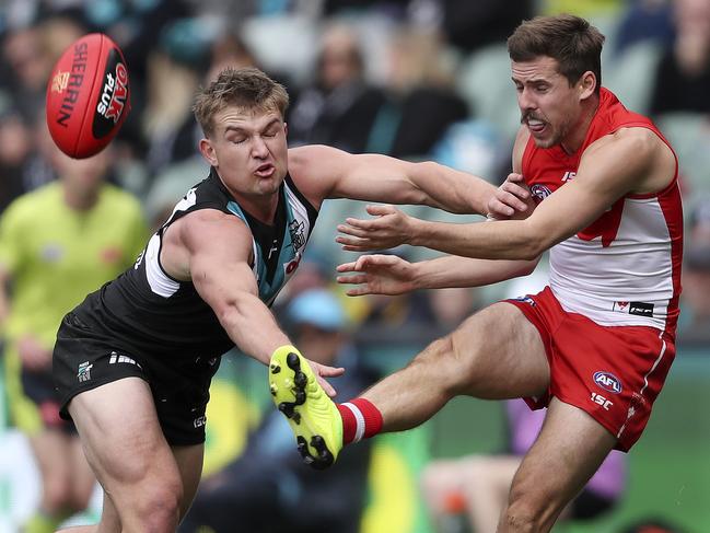 AFL - Port Adelaide v Sydney Swans - Round 21 - Adelaide Oval. Ollie Wines tries to smother the kick of Jake Lloyd Picture SARAH REED