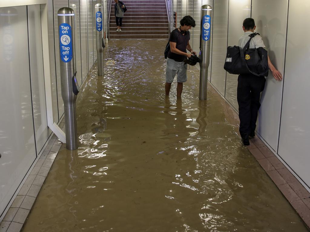 Commuters struggle against torrential rain and gale force winds in Lewisham as Sydney is lashed with a monumental early summer storm, 28/11/18. Picture: Nicholas Eagar