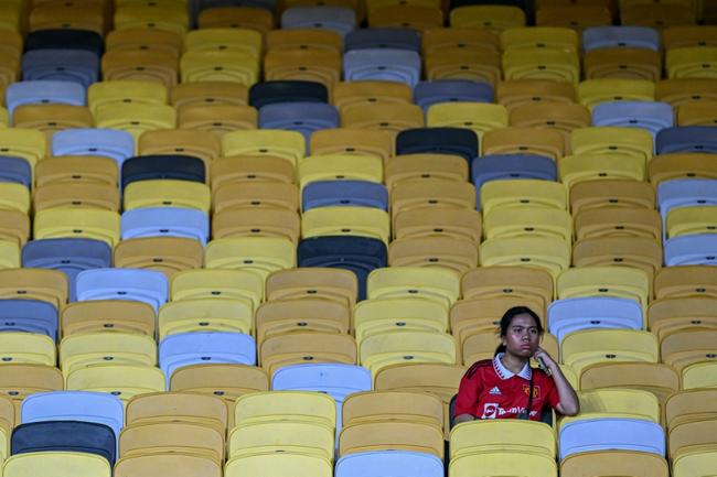 A fan sits in the stands before the friendly between Manchester United and  Asean All-Stars