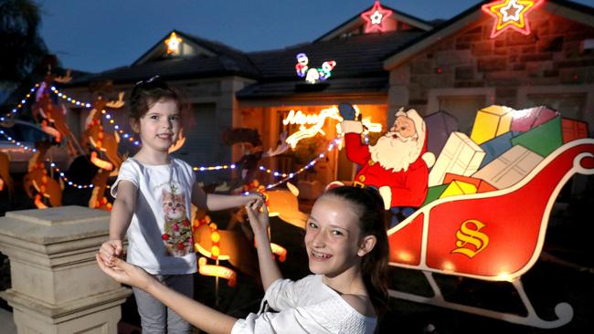 Winter, 5, and her sister, Tulip, 13, have a look at the Christmas lights on Joslin St. Picture: AAP/Dean Martin