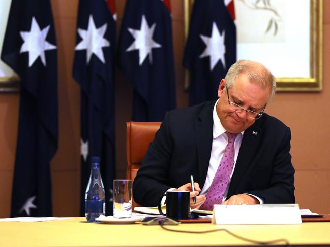 Scott Morrison takes notes on a video conference call with the “first movers” group. Picture: Adam Taylor/PMO