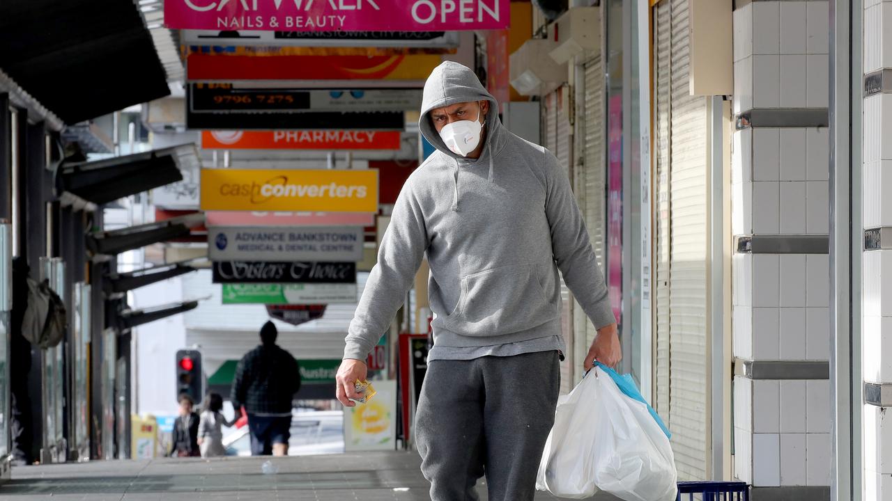 A man walks down an empty Bankstown City Plaza. Picture: Toby Zerna