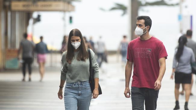 SYDNEY, AUSTRALIA – JANUARY 03: A couple wearing masks walk along The Corso in Manly. (Photo by Jenny Evans/Getty Images)