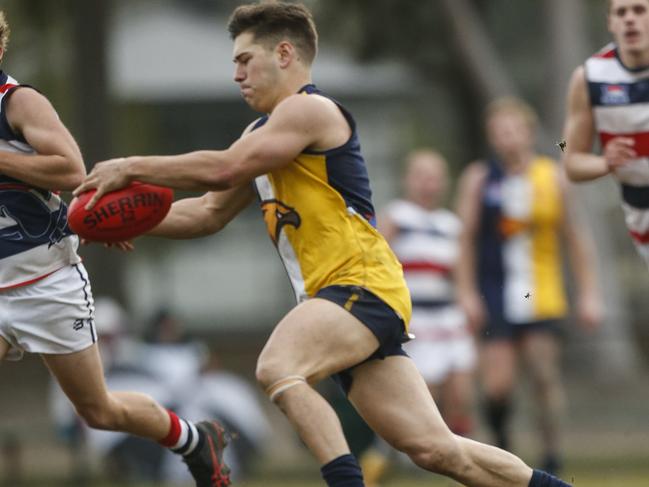 Nick Battle takes a kick for the Doveton Eagles. Picture: Valeriu Campan