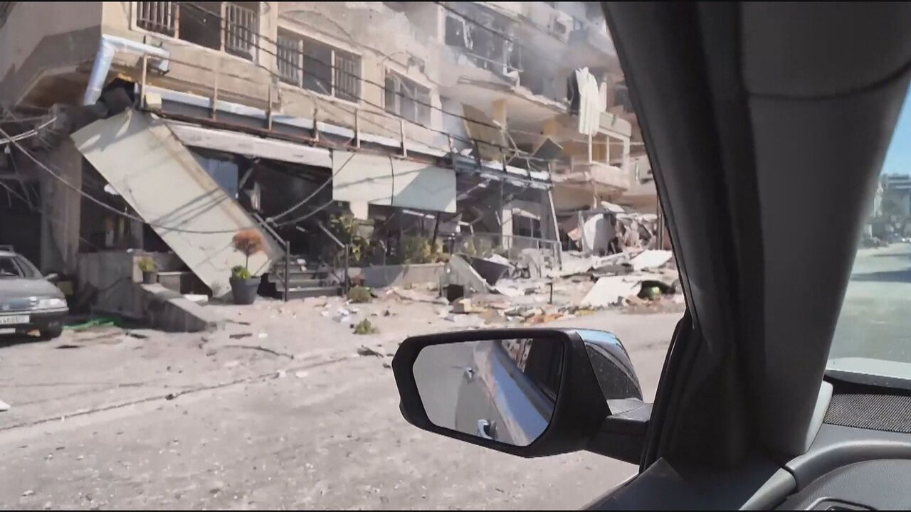 Driving through a city in Lebanon devastated by Israeli air strikes