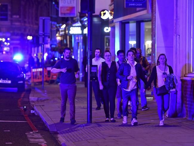 People run down Borough High Street after a terror attack near London Bridge in London. Picture: AP