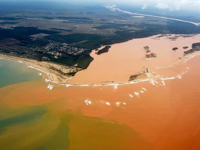 File picture of a handout picture released by the Espirito Santo State Press Office showing an aerial view of the Doce River--which was flooded with toxic lama after a dam owned by Brazilian Vale SA and Australian BHP Billiton Ltd burst early this month-- flowing into the Atlantic Ocean in Regencia, Espirito Santo State, Brazil, on November 24, 2015. A Brazilian federal prosecutor announced aggravated manslaughter charges on October 20, 2016 against 21 people, including senior executives, allegedly responsible for the deadly collapse of the Samarco iron ore mine dam last year. The prosecutor, Jose Leite Sampaio, made the announcement in a televised press conference in Belo Horizonte, near the site of the disaster on November 5, 2015, when the failed dam unleashed a torrent of muddy water killing 19 people. It was branded Brazil's worst ever environmental disaster. / AFP PHOTO / Espirito Santo state Press Offic / FRED LOUREIRO / RESTRICTED TO EDITORIAL USE - MANDATORY CREDIT "AFP PHOTO /ESPIRITO SANTO STATE PRESS OFFICE / FRED LOUREIRO" - NO MARKETING - NO ADVERTISING CAMPAIGNS - DISTRIBUTED AS A SERVICE TO CLIENTS