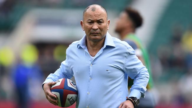 England's head coach Eddie Jones carries a rugby ball as his players warm up ahead of the Six Nations international rugby union match between England and Scotland at Twickenham stadium in south west London on March 11, 2017. / AFP PHOTO / Glyn KIRK