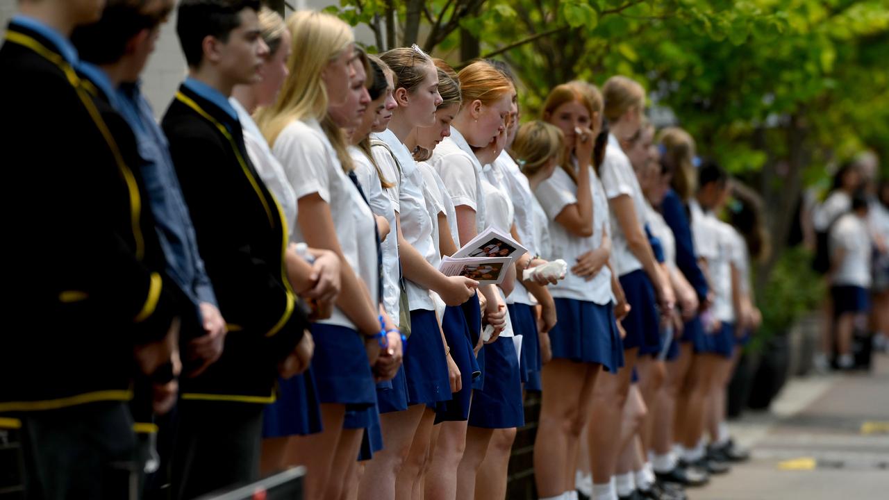 Mourners form a guard of honour as the hearse leaves the memorial service for Whakaari/White Island volcano victims Anthony, Elizabeth and Winona Langford at Maris College North Shore Auditorium in Sydney, Monday, December 30, 2019. Picture: Bianca De Marchi/AAP