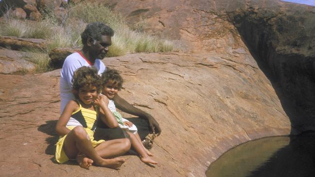 Kenneth Ngalatiji Ken with his daughters, Rebekah and Tjunkaya, at a rock pool in the APY Lands: The Ken Family