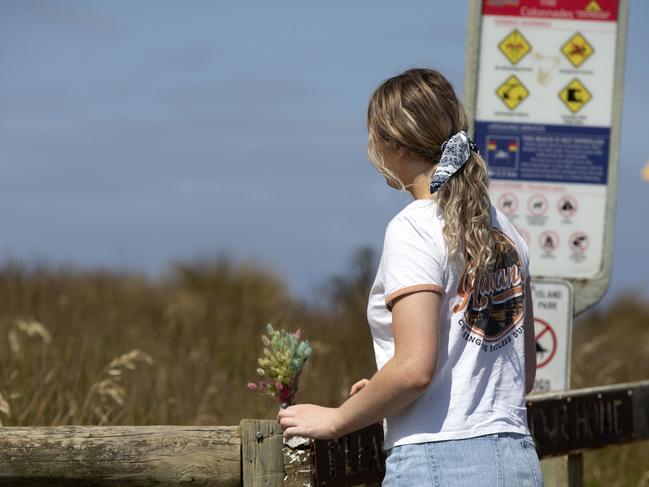 A young girl leaves flowers at The Colonnades after the Christmas Eve drownings. Picture: Sarah Matray